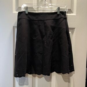 Black skirt with eyelet design.